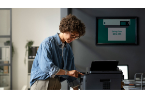 woman standing near printer pushing print